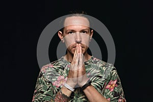 Close up portrait of young man isolated on black studio background