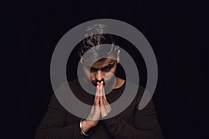 Close up portrait of young man isolated on black studio background