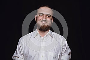 Close up portrait of young man isolated on black studio background