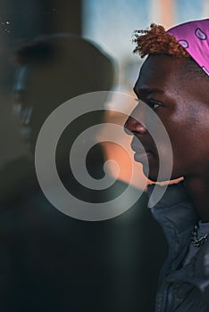 Close up portrait of young man with reflection in window