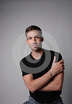 Vertical portrait of young man with serious face expression. White background. photo