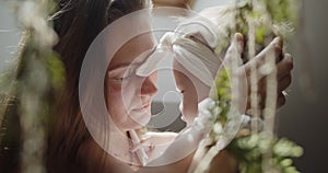 Close-up portrait of young mother holding her cute little baby daughter