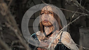 Close up portrait of young nun. Nun is praying. Beautiful woman in old fashioned dress and big gold cross