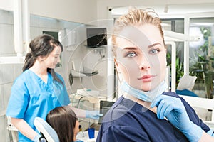 Close-up portrait of young orthodontist in dental clinic