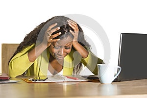 Close up portrait of young sad and depressed black afro American business woman crying while working at office computer desk feeli