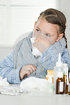 Close up portrait of young sick girl with medicines