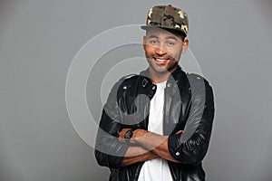 Close-up portrait of young smiling african man in stylish cap st