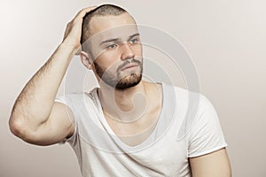 Close up portrait of a young sporty, fit man in pensive mood