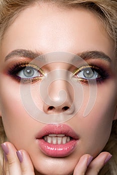 Close-up portrait of young surprised woman touching her face