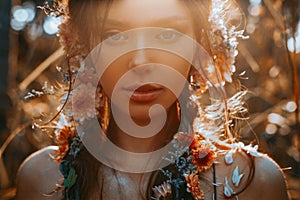 Close up portrait of young and tender woman on a feild at sunset