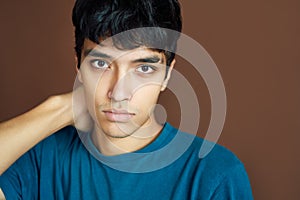 Close up portrait of young thoughtful man on studio background