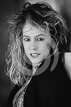 Close up portrait of young woma with curly hair. Black and white portrait