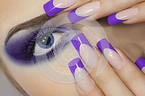 Close up portrait of young woman with big blue eyes and prefect manicure. photo
