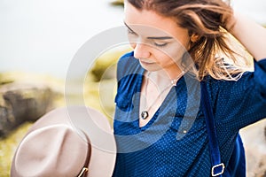 Close up portrait of young woman with brown hat outdoor.having fun on the sea