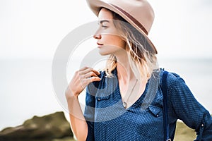 Close up portrait of young woman in brown hat outdoor.having fun on the sea