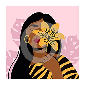 Close up portrait of young woman holding tiger lily. Woman with exotic tropical flower. Design concept for fashion