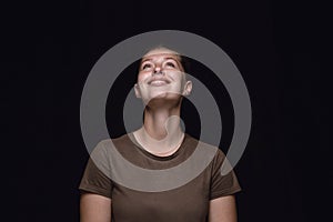 Close up portrait of young woman isolated on black studio background