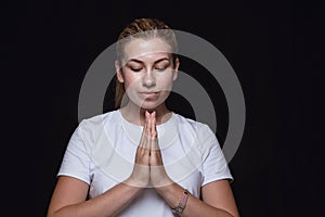 Close up portrait of young woman isolated on black studio background