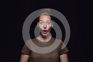 Close up portrait of young woman isolated on black studio background