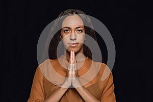 Close up portrait of young woman isolated on black studio background