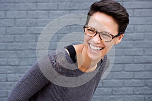 Close up portrait of a young woman laughing with glasses