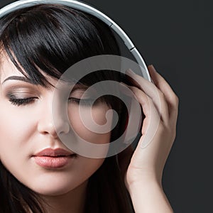 Close-up portrait of young woman listening to music