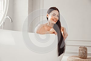 Close-up portrait of a young woman relaxing in the bathtub