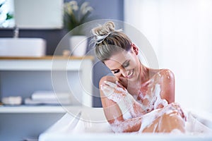 Close-up portrait of a young woman relaxing in the bathtube