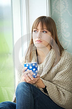 Young Woman Relaxing with Cup of Tea