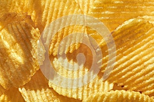 Close up potato chips top view food background.