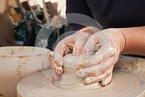 Close Up Of Potter Moulding Clay On Wheel