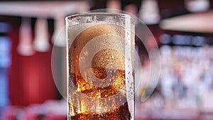 Close up pour fresh foamy cold coke soda beverage into glass slow motion. 4k Dragon RED camera