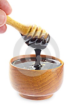 Close up pouring chocolate melt into wooden bowl