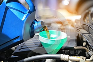 Close up of Pouring fresh oil to car engine in auto repair service, Change oil