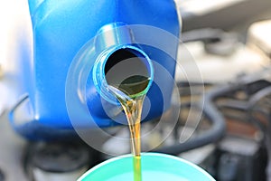 Close up of Pouring fresh oil to car engine in auto repair service, Change oil