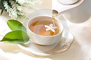 Close up pouring hot jasmine tea in a white tea cup , Tea cerem