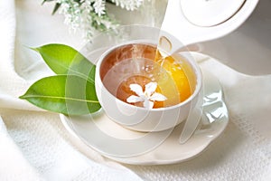 Close up pouring hot jasmine tea in a white tea cup , Tea cerem