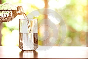 Close up the pouring purified fresh drink water from the bottle