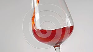 Close up of pouring red sweet wine in glass