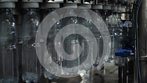 Close-up of pouring water into a plastic bottle with a volume of 1.5 liters in the filling unit. Shop for the production of minera