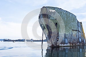 Close up of a Powell River concrete ship with two other ships in the background that make up the floating breakwater