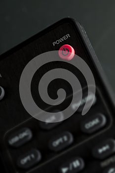 Close-up of Power button on - off on remote control for TV and audio in black color. With copy space