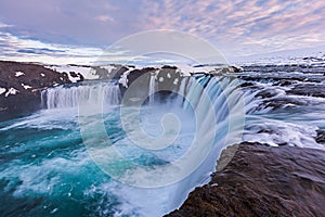 Close up powerful godafoss falls in sunet.