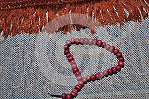 Close up prayer beads isolated on prayer rug