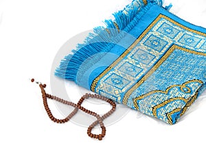 Close-up prayer rug and rosary, Islam and prayer rug, on the prostration Muslims pray on