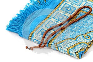 Close-up prayer rug and rosary, Islam and prayer rug, on the prostration Muslims pray on