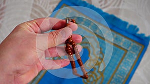 Close-up prayer rug and rosary, Islam and prayer rug, on the prostration Muslims pray on