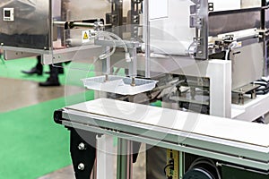 close up precision vacuum suction cup gripper with automatic limb during sucking pick â€“ place plastic box on belt conveyor