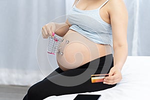 Close up of pregnant shopping baby products for children