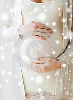 Close up of pregnant woman belly and hands
